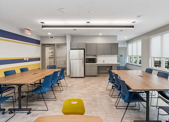 A conference room with a long table and chairs.