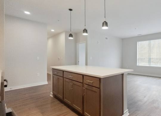 A kitchen with wooden cabinets and a white countertop.