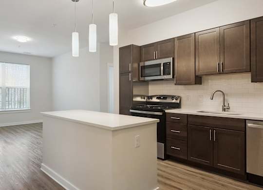 A kitchen with brown cabinets and a white island.