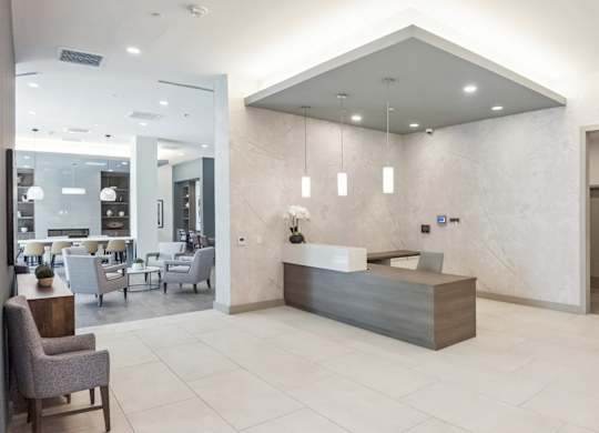 A reception area with a counter and chairs.