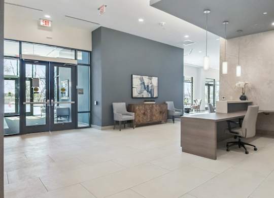 A modern office space with a reception desk and a chair.