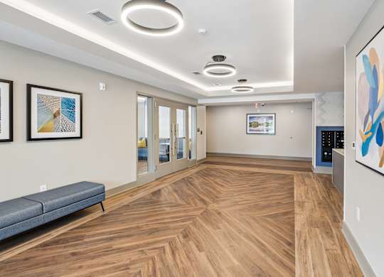 A hallway with a bench and pictures on the wall.