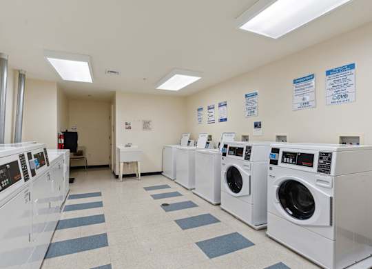 a laundry room with washers and dryers
