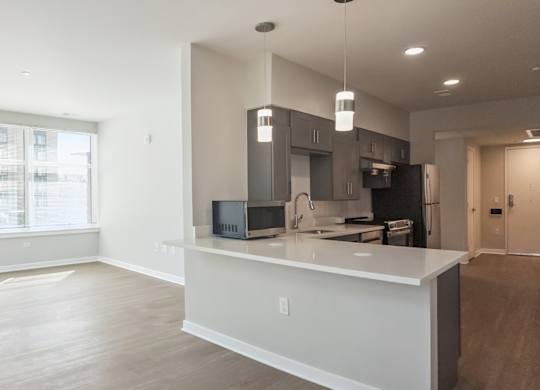 A modern kitchen with a large island and stainless steel appliances.