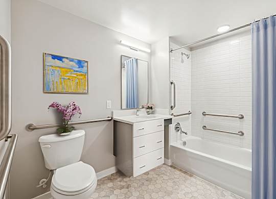 A bathroom with a toilet, sink, and bathtub.
