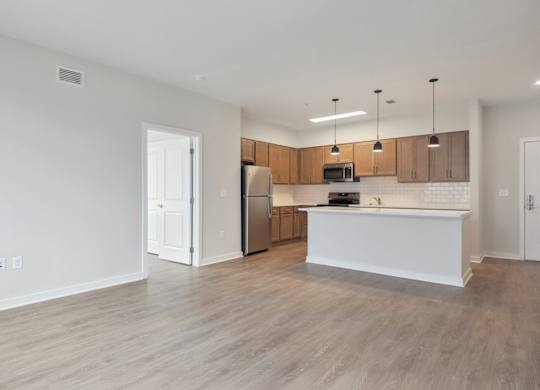 A kitchen with wooden cabinets and a white island.