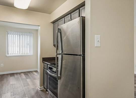 A kitchen with a stainless steel refrigerator and oven.