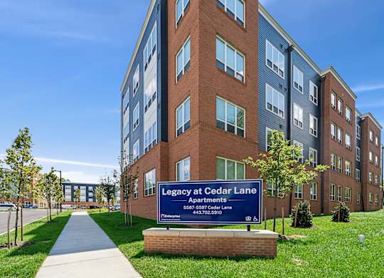 A large brick building with a sign that says Legacy at Cedar Lane.