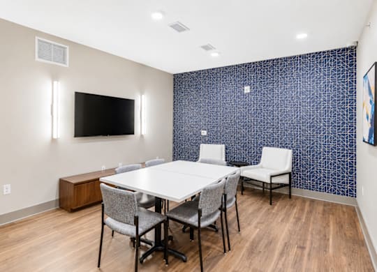 A conference room with a white table and chairs.