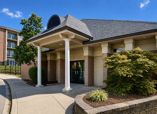 A building with a grey roof and white columns.