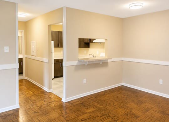 A room with wooden floors and white walls.