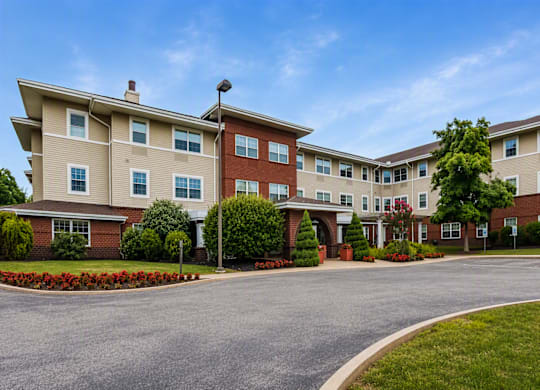 A large apartment complex with a driveway in front.