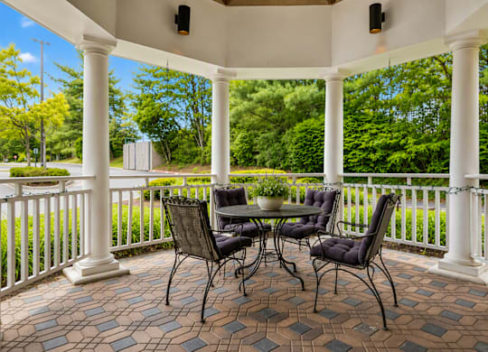 A patio with a table and chairs.