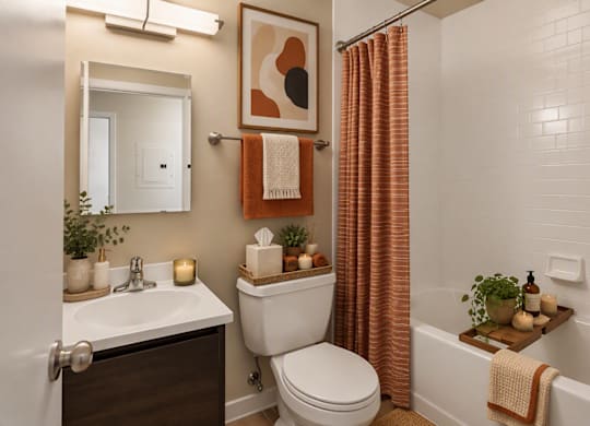 A bathroom with a toilet, sink, and a shower curtain.