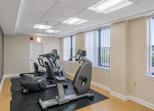 A room with a treadmill and a stationary bike.