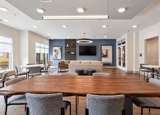A conference room with a long table and chairs.