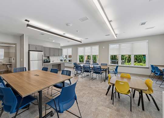 A conference room with a large table surrounded by chairs.