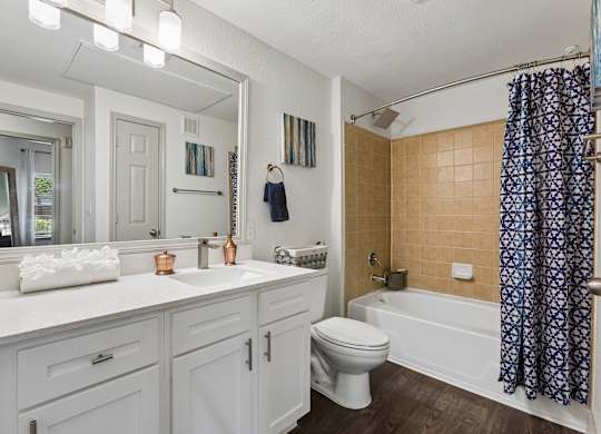 A bathroom with a white toilet and a white sink.