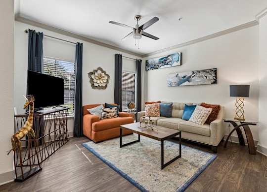 A living room with a giraffe sculpture and a sofa.