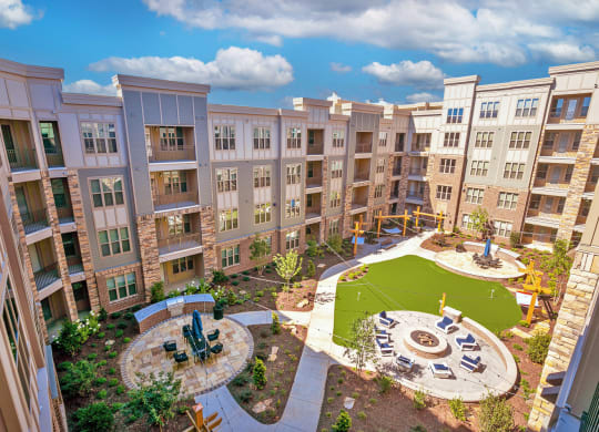 an aerial view of an apartment complex with a playground and fountain