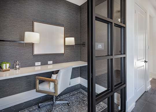 A modern bathroom with a chair and a mirror at Folksong Apartments, Flowery Branch, GA