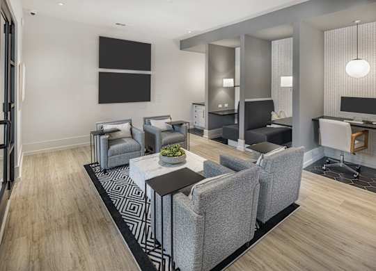 A modern living room with grey furniture and a black and white rug at Folksong Apartments, Georgia 30542