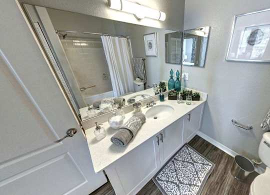 Bathroom with a white vanity with a mirror at Tuscany Bay Apartments, Tampa, FL