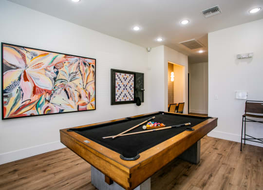 Octave Apartments  a game room with a pool table and a painting on the wall at Octave Apartments, Nevada