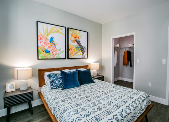 Octave Apartments a bedroom with a large bed and two paintings on the wall at Octave Apartments, Las Vegas, NV, 89123