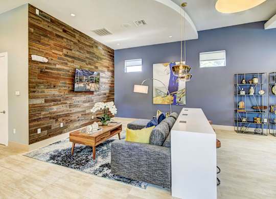 Modern resident lounge area with a television on a patterned wall at Tuscany Bay Apartments, Tampa, 33626