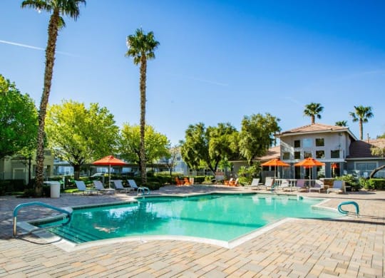 Octave Apartments in Las Vegas, Nevada Clubhouse Exterior and Large Pool with Lounge Chairs at Octave Apartments, Nevada