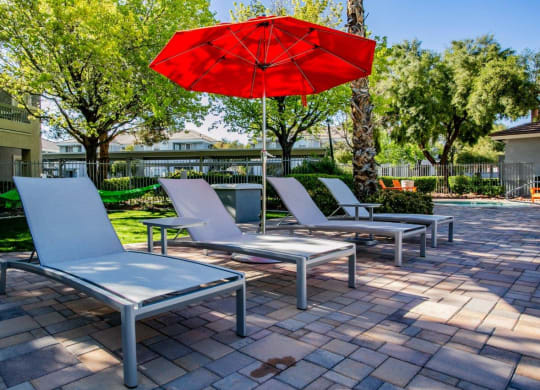 Octave Apartments in Las Vegas, Nevada Poolside Lounge Chairs and Umbrella at Octave Apartments, Nevada, 89123