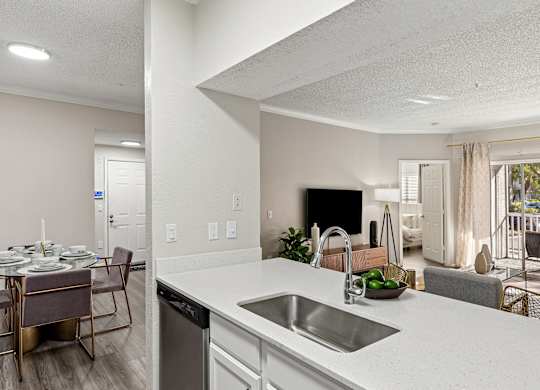 A modern kitchen with a dining table set for four.