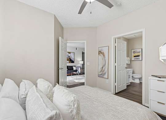 A bedroom with a bed, dresser, and mirror.