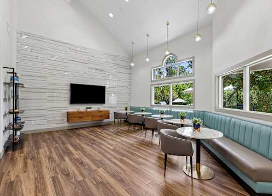 A modern living room with a wooden floor and a flat screen TV.