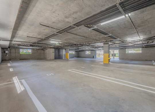 A large, empty parking garage with concrete floors and walls.