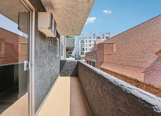 A long, narrow, outdoor walkway between two buildings.