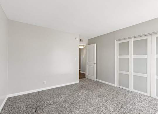 A room with a carpeted floor and white walls.