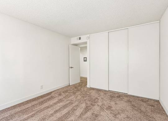 A room with a carpeted floor and white walls.