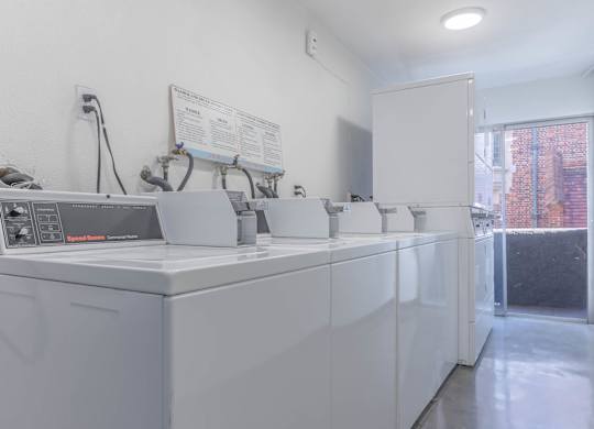 A white laundry room with a washing machine and dryer.