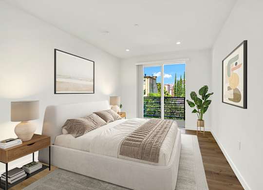 A bedroom with a large bed and a view of the city.