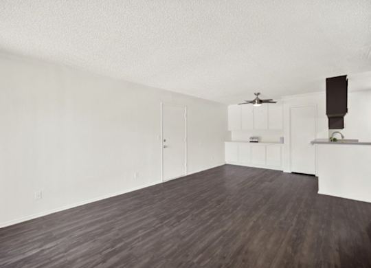 A room with a ceiling fan and a kitchenette at Monterra Ridge Apartments, Canyon Country, California