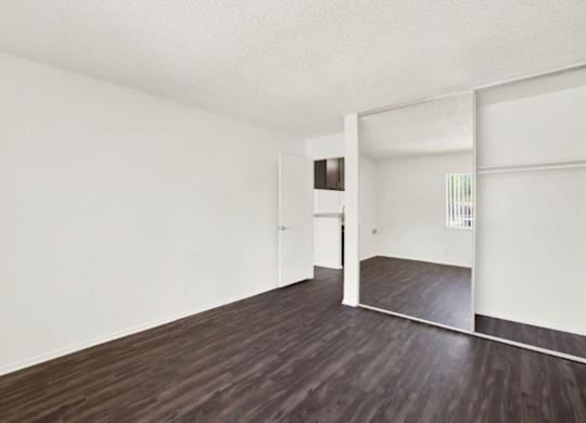 A room with wooden floors and white walls at Monterra Ridge Apartments, Canyon Country, California