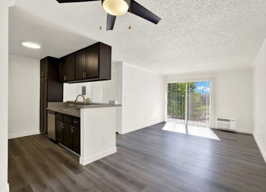 A kitchen with dark brown cabinets and a white countertop at Monterra Ridge Apartments, Canyon Country