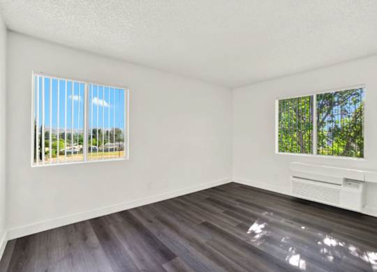 A room with a window and a wooden floor at Monterra Ridge Apartments, Canyon Country