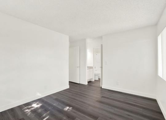 A room with wooden floors and white walls at Monterra Ridge Apartments, Canyon Country