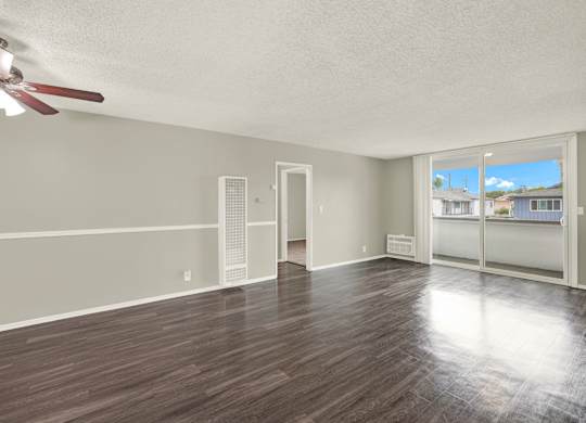 A room with a ceiling fan and wooden flooring at The Square in Downey, CA, 90242
