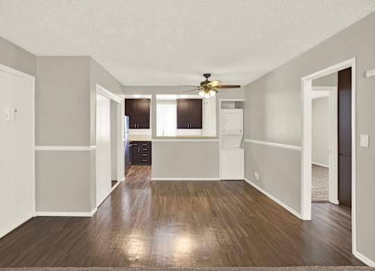 A room with a ceiling fan and wooden floors at The Square in Downey, CA, 90242