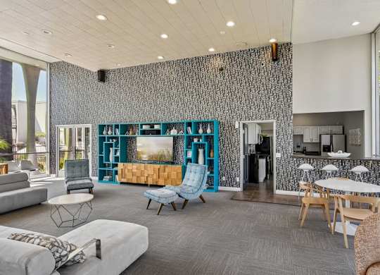 A modern living room with a grey carpet and a white sofa.