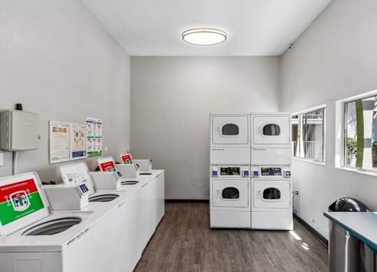 A laundry room with washers and dryers.